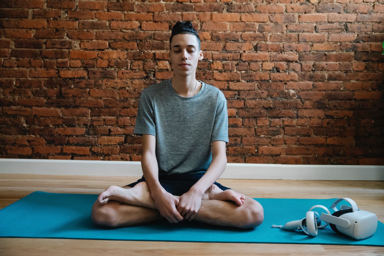 teen boy meditating on blue yoga mat